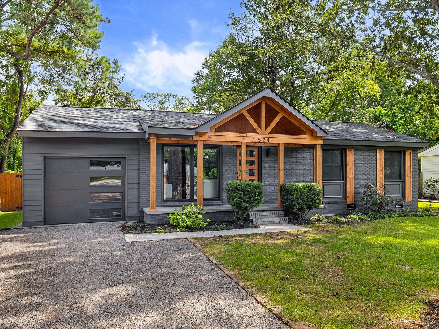 Gray-brick Charleston ranch with a warm cedar timber porch gable